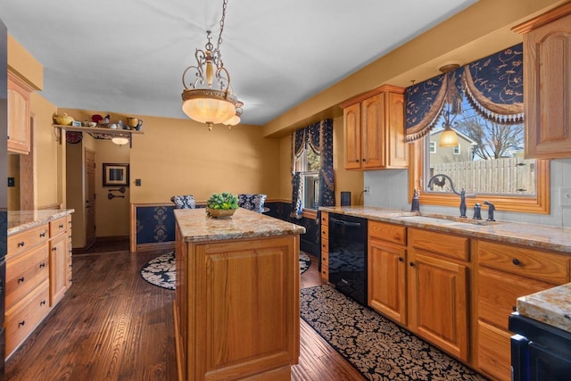 kitchen with dark wood finished floors, black dishwasher, a kitchen island, and a sink