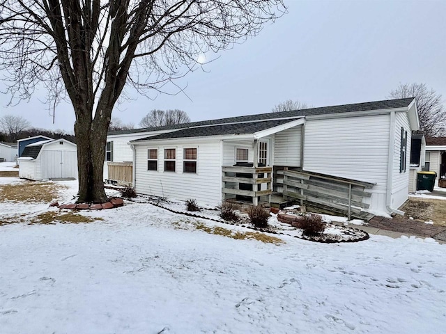 view of front of house featuring a garage, an outdoor structure, and a storage unit