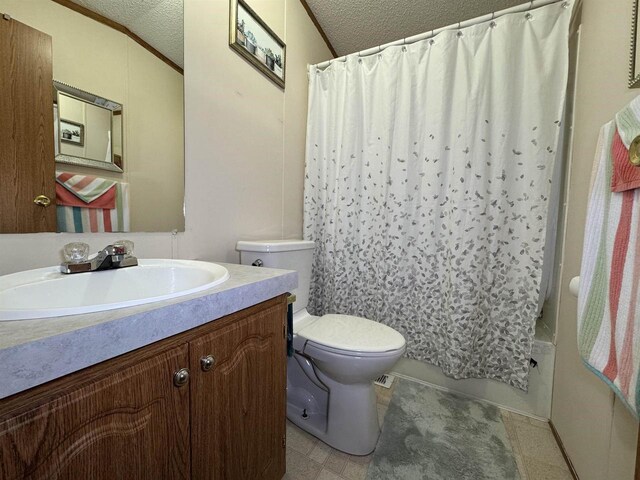 2701 E Main St Unit 118, Reedsburg, WI 53959 - bathroom with vanity, lofted ceiling, shower / bath combination with curtain, a textured ceiling, and toilet