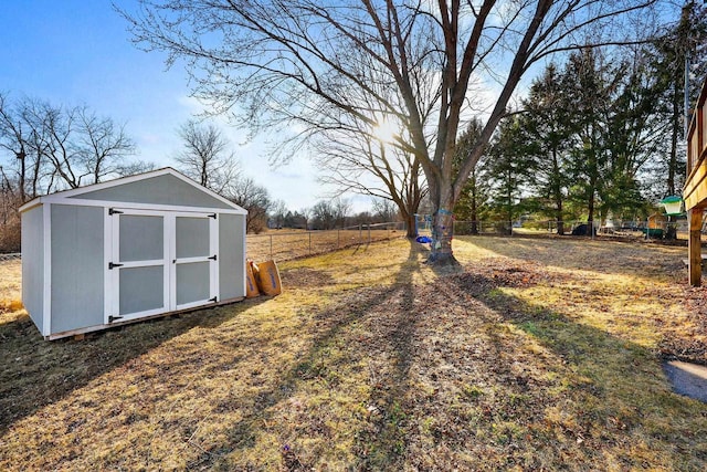 view of yard with a storage unit, an outbuilding, and a fenced backyard