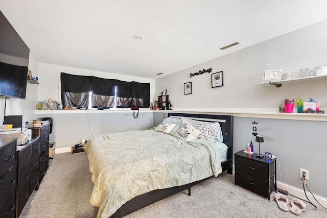 bedroom featuring visible vents, baseboards, and carpet