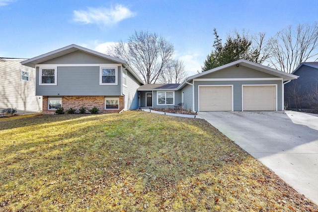 tri-level home with brick siding, driveway, a front yard, and a garage