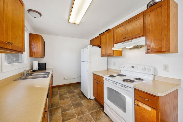 kitchen featuring under cabinet range hood, white appliances, brown cabinets, and a sink