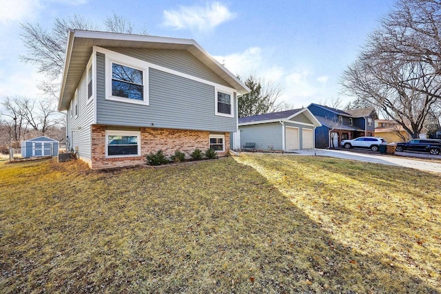 split level home with a garage, an outbuilding, brick siding, and a front yard