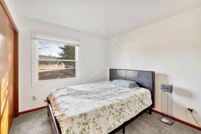 carpeted bedroom featuring baseboards