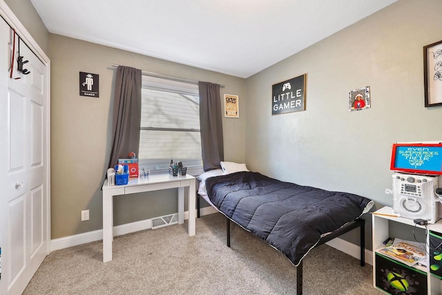 bedroom featuring carpet and baseboards