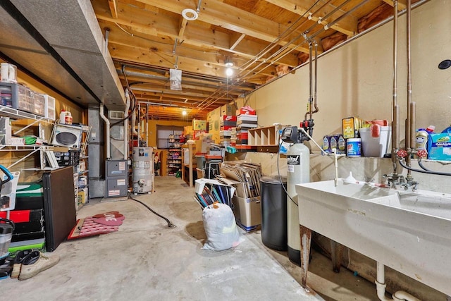 unfinished basement featuring heating unit, gas water heater, and a sink