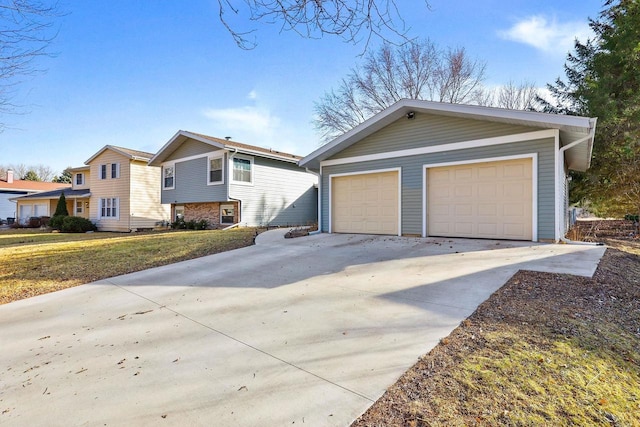 view of front of house with a front yard and a garage