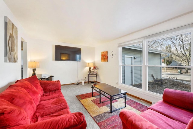 carpeted living room with baseboards