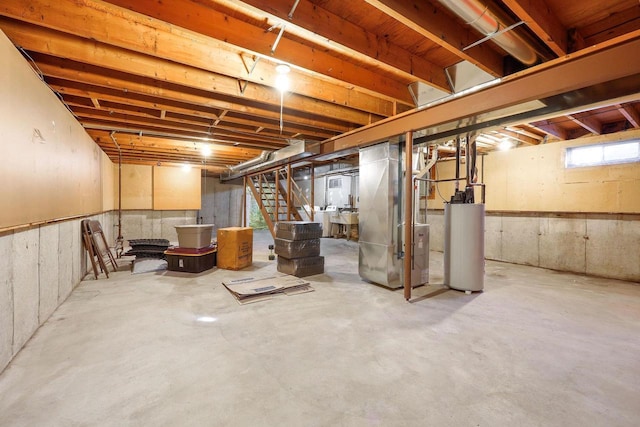 below grade area featuring heating unit, stairway, and gas water heater