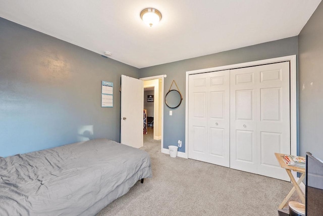 bedroom featuring a closet, carpet floors, and baseboards