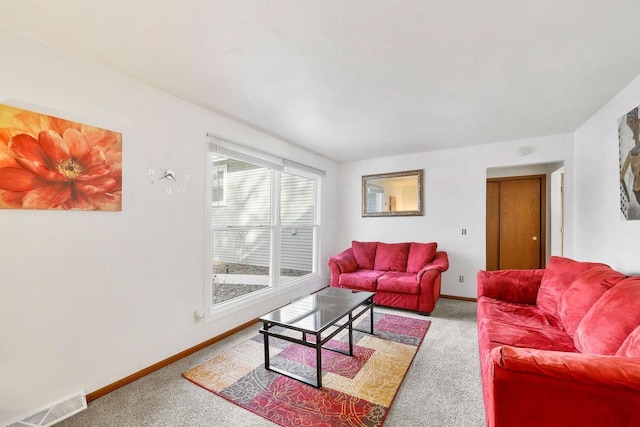 carpeted living area with visible vents and baseboards