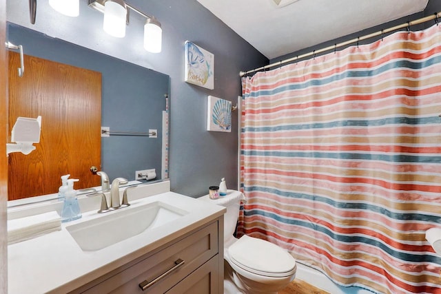 bathroom featuring toilet, vanity, and a shower with curtain