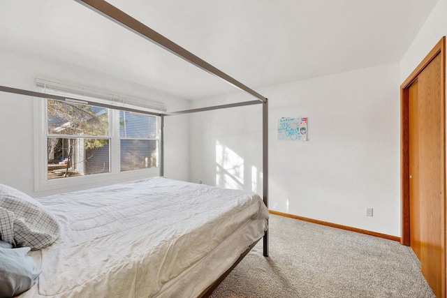 carpeted bedroom featuring baseboards