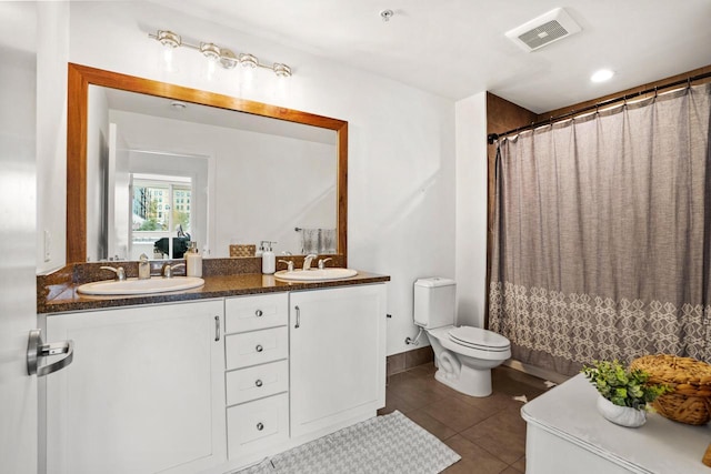 bathroom with visible vents, a sink, toilet, and tile patterned floors