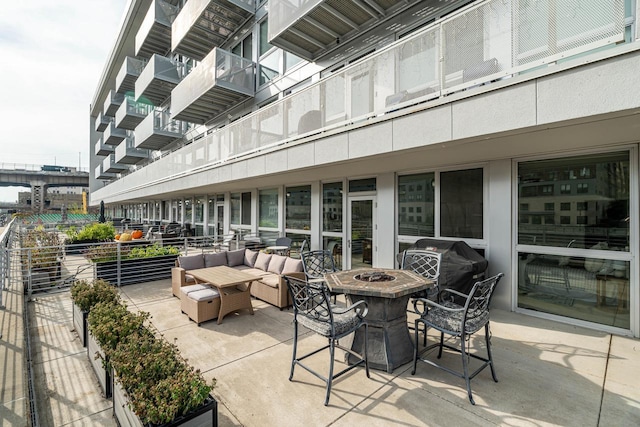 view of patio / terrace featuring an outdoor fire pit and a grill