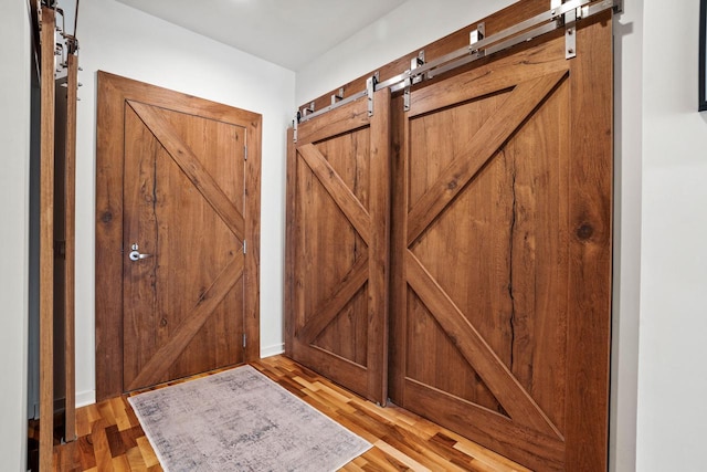 interior space featuring a barn door and light wood-type flooring