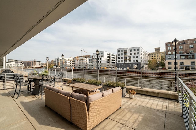 view of patio / terrace with an outdoor living space and a city view