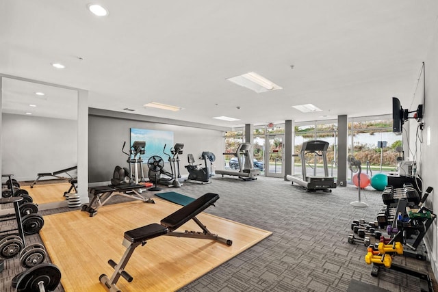 exercise room featuring a wall of windows, carpet, and recessed lighting