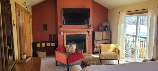 living area featuring lofted ceiling and a fireplace