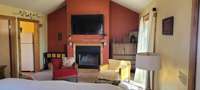 living area with vaulted ceiling and a fireplace