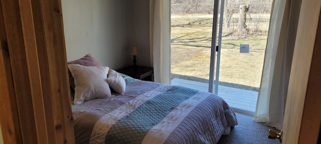 bedroom with carpet and access to exterior