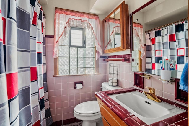 bathroom with a shower with curtain, toilet, tile walls, and vanity