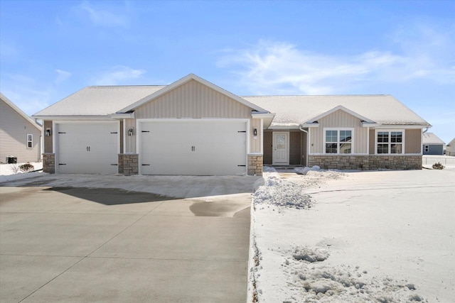 view of front of property with a garage, stone siding, board and batten siding, and concrete driveway