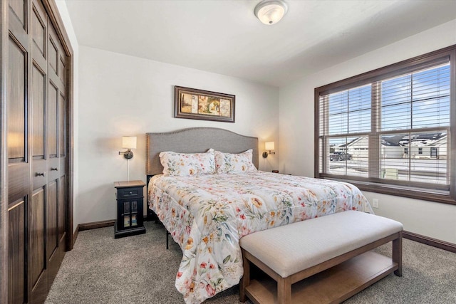 bedroom with a closet, baseboards, and carpet flooring