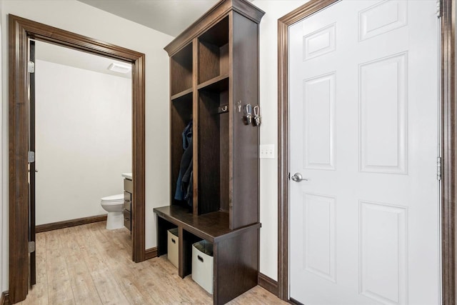 mudroom featuring light wood finished floors and baseboards