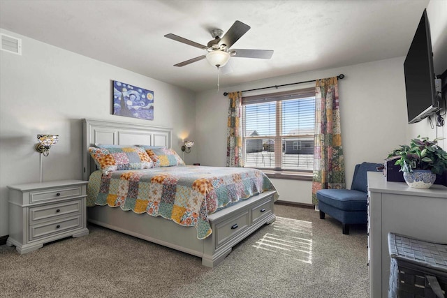 bedroom with light carpet, a ceiling fan, visible vents, and baseboards