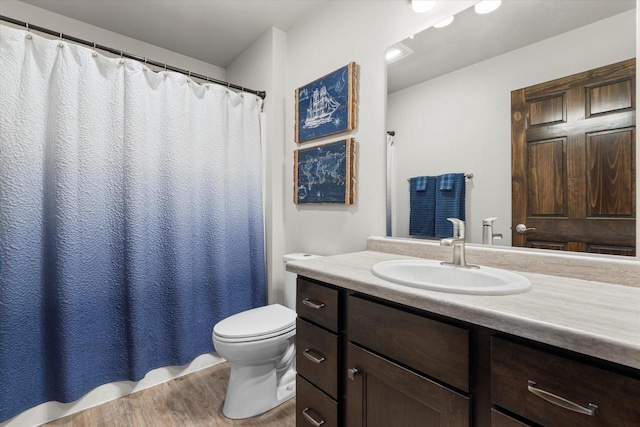 bathroom featuring wood finished floors, vanity, toilet, and a shower with curtain