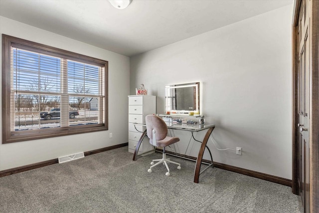 carpeted home office featuring visible vents and baseboards