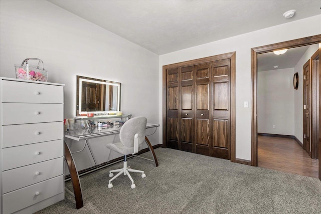 home office featuring lofted ceiling, baseboards, and carpet flooring