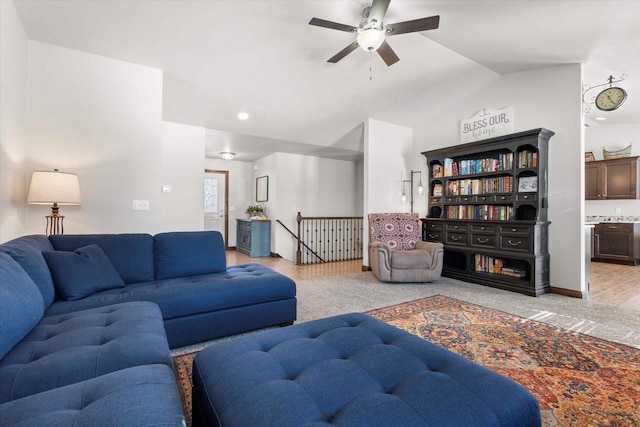 living room featuring lofted ceiling, light carpet, and a ceiling fan