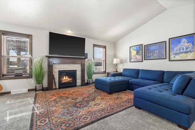 carpeted living area featuring baseboards, a fireplace, visible vents, and vaulted ceiling