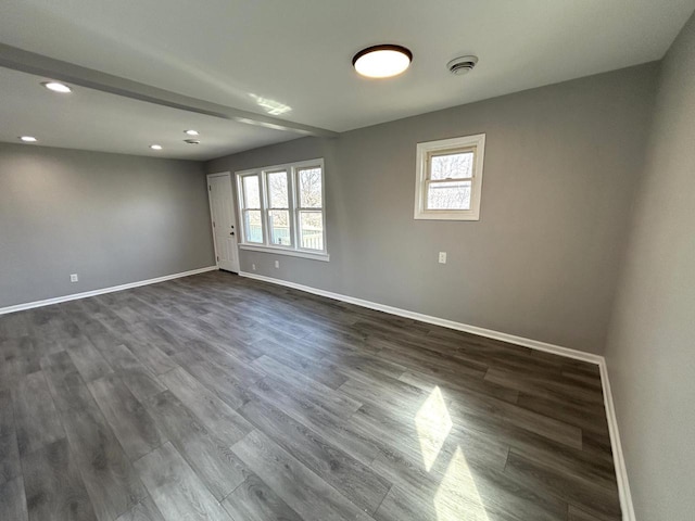 spare room featuring dark wood-style floors, recessed lighting, and baseboards