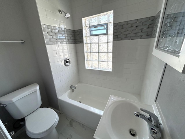 full bath with a wealth of natural light, marble finish floor, toilet, and a sink