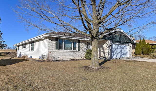 view of front of house featuring brick siding and concrete driveway