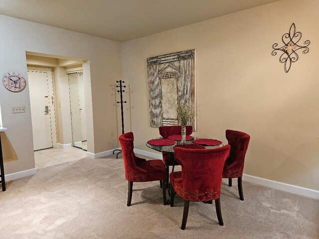 dining area with baseboards and carpet floors