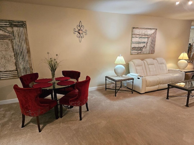 dining room featuring carpet flooring and baseboards