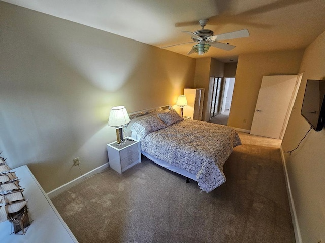 carpeted bedroom with a ceiling fan and baseboards