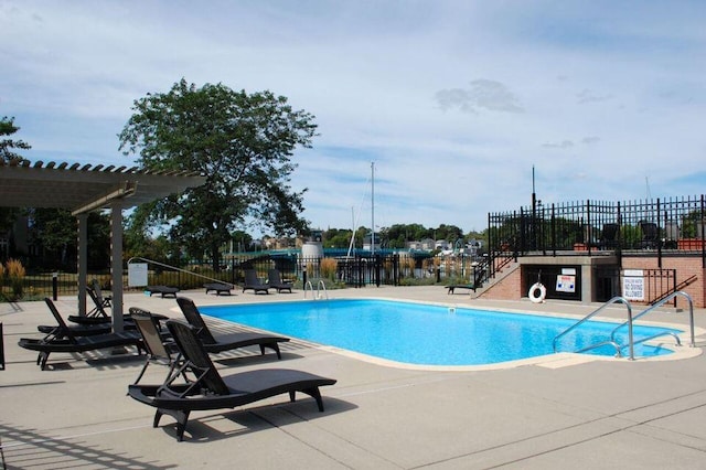 community pool featuring a patio area, fence, and a pergola