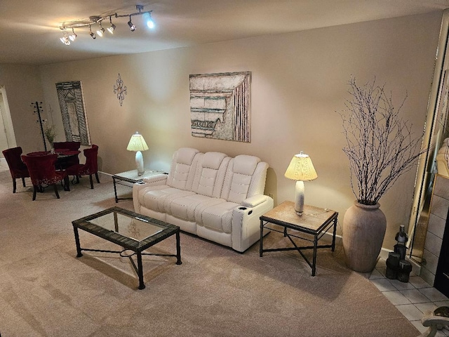 tiled living room featuring rail lighting and carpet flooring