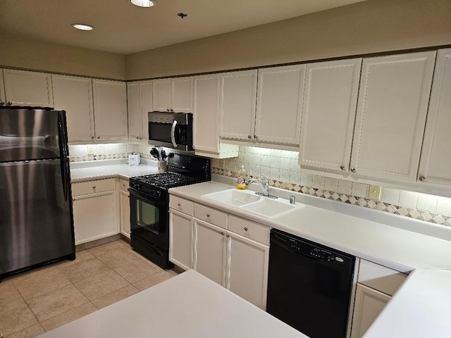 kitchen featuring light tile patterned floors, a sink, black appliances, light countertops, and tasteful backsplash