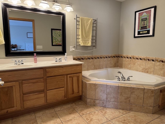 bathroom featuring tile patterned floors, double vanity, a garden tub, and a sink