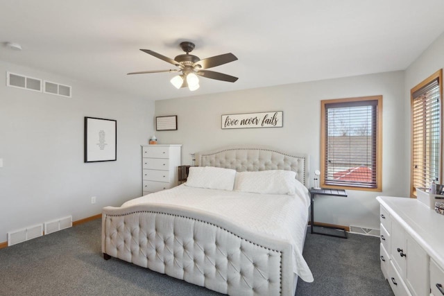 bedroom with visible vents, dark carpet, baseboards, and ceiling fan