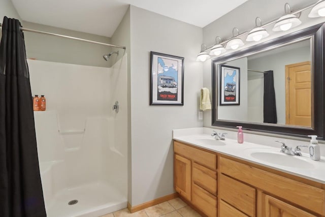 bathroom with tile patterned flooring, double vanity, a shower with curtain, and a sink