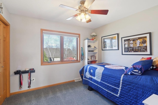 carpeted bedroom with visible vents, a ceiling fan, and baseboards