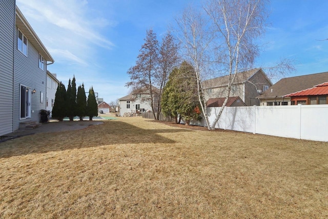 view of yard with a patio area, a residential view, and fence